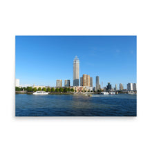 Lade das Bild in den Galerie-Viewer, Stretch of high rise buildings overlooking harbor on a sunny day