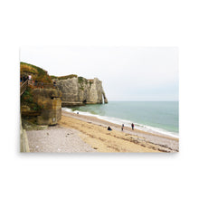 Load image into Gallery viewer, Beach scene with cliffs and people on a cloudy day