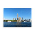 Stretch of high rise buildings overlooking harbor on a sunny day
