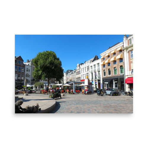 Square with buildings, trees, and people on a sunny day