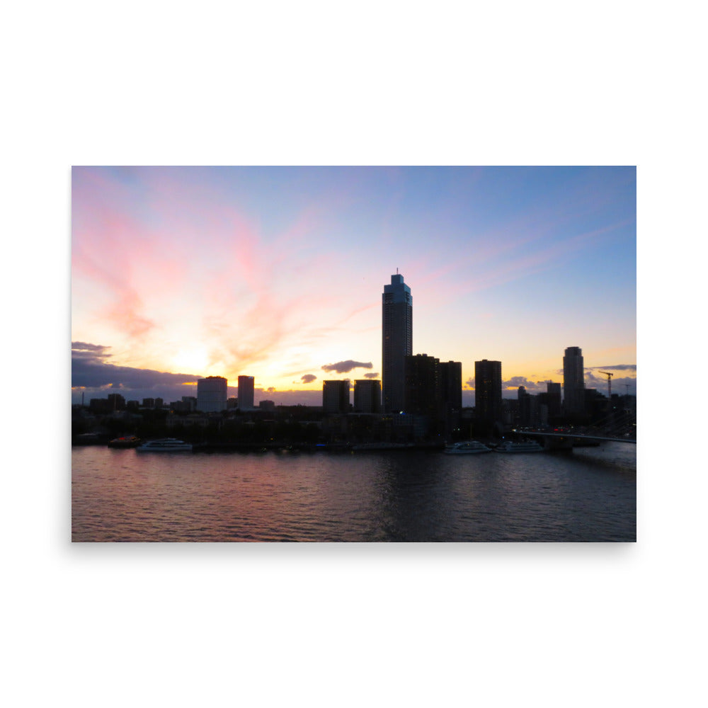 City skyline at sunset with a colorful sky over water
