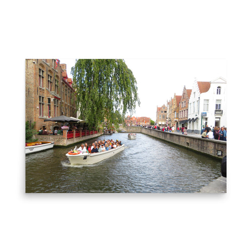 Boats on a canal with people and buildings in the background