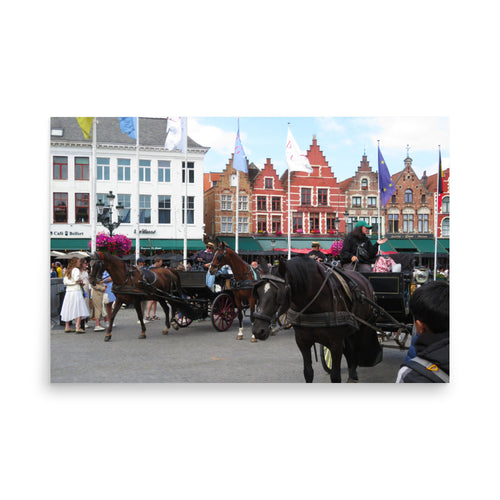 Horses pulling carriages in a town square with colorful buildings in the background