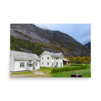 Two white houses with a mountainous background
